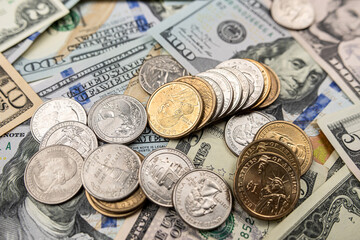 different United States dollar bills with coins for background