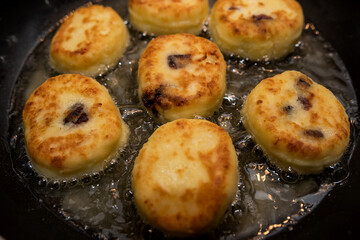 fresh tasty cheese pancakes cheesecakes are fried in a pan, ukraine traditional food