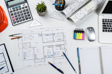 Naklejka na ściany i meble House plan blueprint paper with laptop pencil calculator on architecture office desk