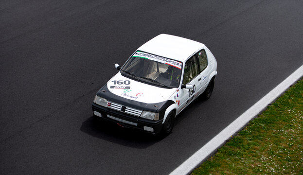 Vintage racing car, classic retro motor sport action, Peugeot 205 Rally on asphalt race track