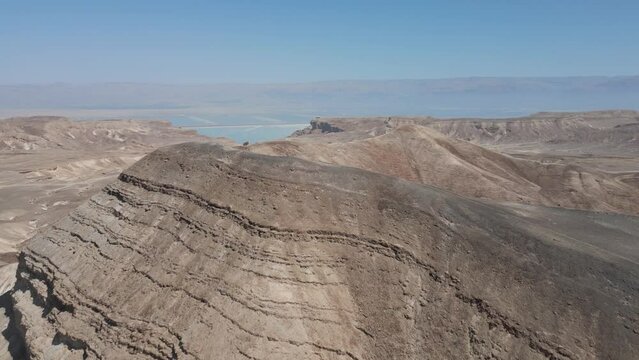 Aerial drone reveal dark and yellow mountains  in the desert near Arad and the dead sea, Negev, Israel with dramatic scenery with blue sky during winter 