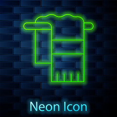 Glowing neon line Towel on hanger icon isolated on brick wall background. Bathroom towel icon. Vector