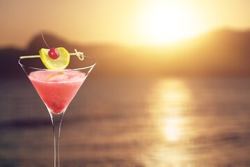 Tasty sweet alcohol drink on sea background