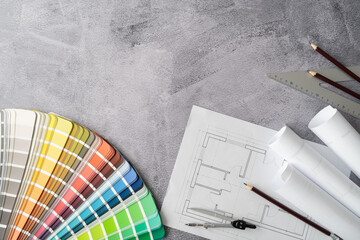 Home floor plans, building blueprint project, open color palette guide catalog with colour swatches. Architect or interior design concept. Choosing paint colors for house. Flat lay with copy space.