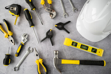 Work tools and safety helmet. Engineer or architect flat lay concept. Set of tools for repair - hammer, screwdrivers, pliers, meter, wrenches and spirit level.