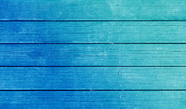 Painted wood deck floor texture background reminiscent of blue sky and mint emerald sea. There is blank empty space for copyspace and can be used for composing