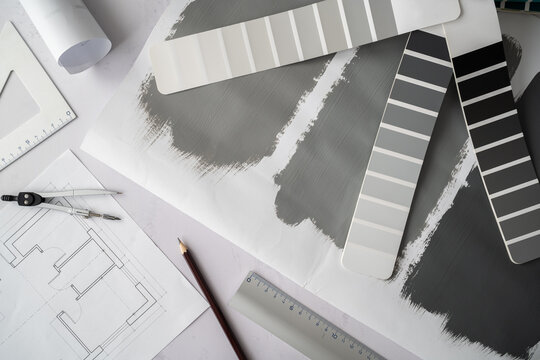 Home floor plans projects and open grayscale color palette guide catalog with colour swatches and painted test paint samples. Interior design concept. Choosing colors for house, flat or apartment.