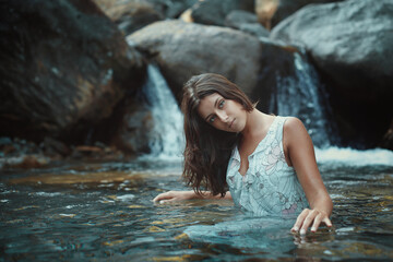 Beautiful woman in mountain stream