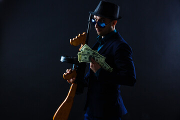 Obraz na płótnie Canvas businessman in sunglasses and with a machine gun.
