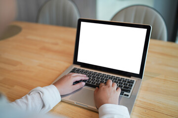 Woman Working by using laptop blank screen computer . Hands typing on a keyboard.technology e-commerce concept.