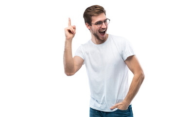 Portrait of a happy young man pointing fingers up at copy space isolated over transparent background