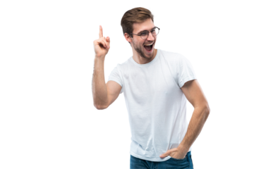 Portrait of a happy young man pointing fingers up at copy space isolated over transparent background