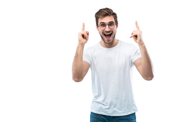Portrait of a happy young man pointing fingers up at copy space isolated over transparent background