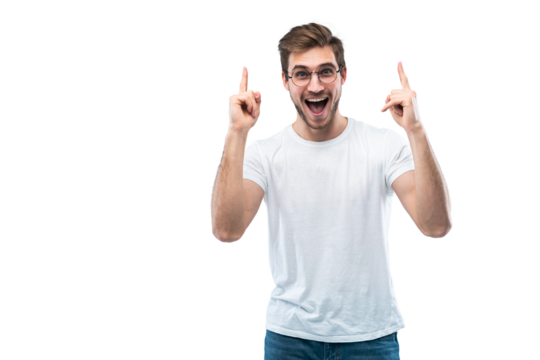 Portrait of a happy young man pointing fingers up at copy space isolated over transparent background