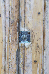 Old wooden door with rusty deadbolt