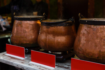 A giant pot full of hot mulled red wine with spices on the Advent Christmas market