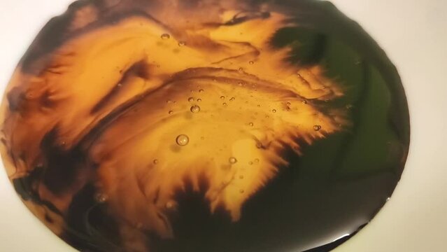 A honey poured into a cup of soy sauce.