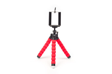 Mini tripod with flexible red legs and mobile phone holder.