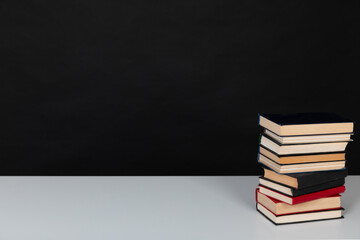 stack of books on a black background science education culture training