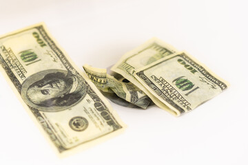 Cleaning a dirty American one hundred dollar bill. money on the black market. Banknotes of 100 dollars in the hands of men near water jets in washbasin