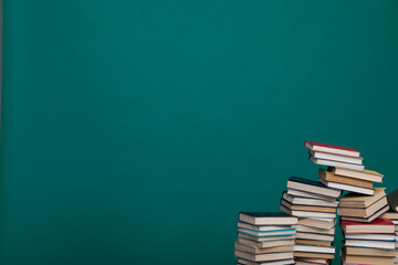 science education stack of books on a green background learning literacy
