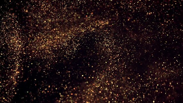golden particles bokeh abstract background with shining gold Floating Dust Particles Flare star on Black Background in Slow Motion.