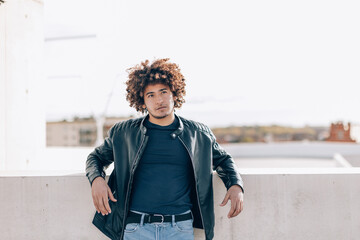 young african american man with afro hair outdoor in bright light