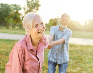 woman man senior couple happy retirement together elderly active vitality park fun smiling love old nature wife happiness mature walking holding hands