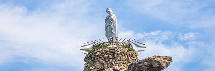 Virgin Mary statue on the Rocher de la Vierge rock in Biarritz - obrazy, fototapety, plakaty