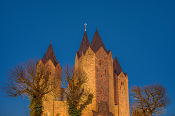 the five towers of Kalundborg church illuminated during the twilight hour