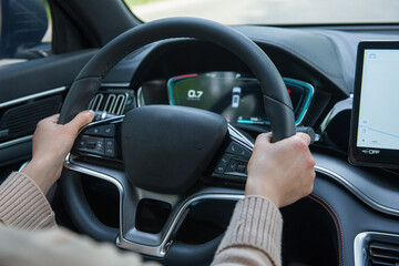 hangd holding steering wheel driving a car.