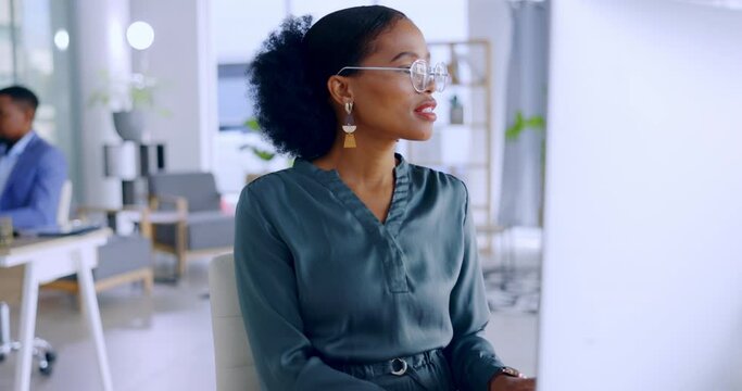 Business woman, computer and typing for communication, email or doing administration at office. African American female employee working on desktop PC in admin, finance or corporate data at work desk