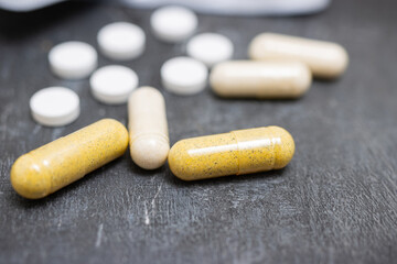 Capsules and white round pills, antibiotic, painkiller or drugs, medicine and healthcare concept, close-up view
