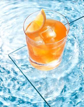 cocktail and lemon in the pool