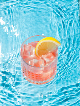 cocktail and lemon in the pool