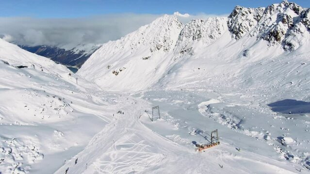 Aerial birds eye shot over ski region with many skier skiing downhill snowy slope in winter season  Kauntertal, Austria
