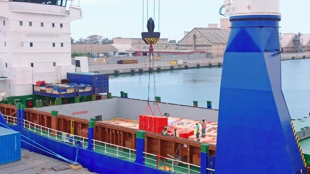 Unloading Goods From Cargo Ship At The Port Of Haina In The Dominican Republic. high angle