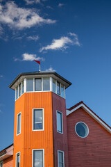 Fototapeta na wymiar Orange House with look-out in Groningen, Netherlands with a blue sky