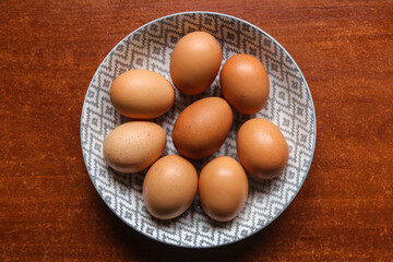 egg ingredient egg in a plate on a dark wooden table on a dark surface