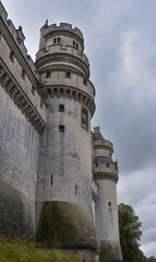 Side view of Chateau de Pierrefonds Castle towers in Pierrefonds, Oise, France with blue sky