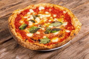 Pizza Margherita Napoletana con sugo di pomodoro, mozzarella di bufala e basilico fresco servita in una pizzeria napoletana 
