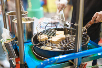 hand cooking Stinky Tofu at night market, famous Taiwanese Street Food of Taiwan. exotic food in local market