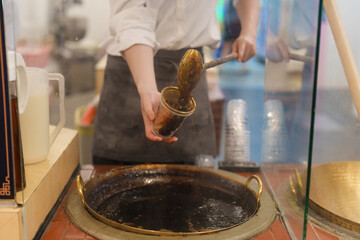 tapioca pearls with brown sugar boba milk tea at night market, famous Taiwanese bubble tea of Taiwan. Street Food and travel in Ximending, Taipei concept