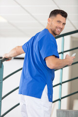 handsome young male nurse climbing hospital stairs