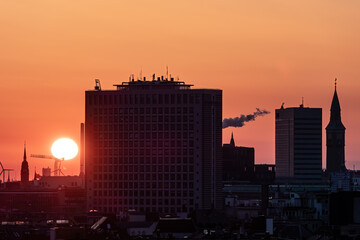 Copenhagen, Denmark The sunrise skyline of the city and buildings in silhouette.