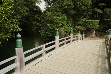 Traditional Bridge, Pond and Japanese Garden at Ritsurin Garden Park in Takamatsu, Kagawa, Japan -...