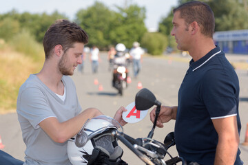people and motorcycle driving lesson