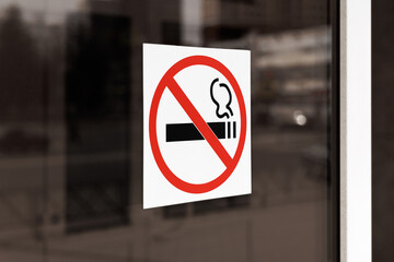 A no smoking sign is affixed to the glass door. Angle view.