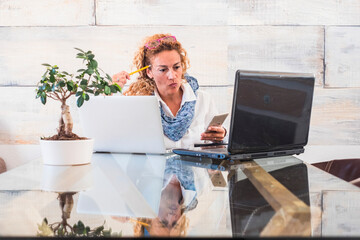 Modern entrepreneur female at home working with laptop computer on the table. New normal online...