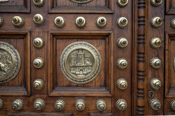 Detail of the metal inlays and patterns of the beautiful wooden door of the general captaincy of barcelona